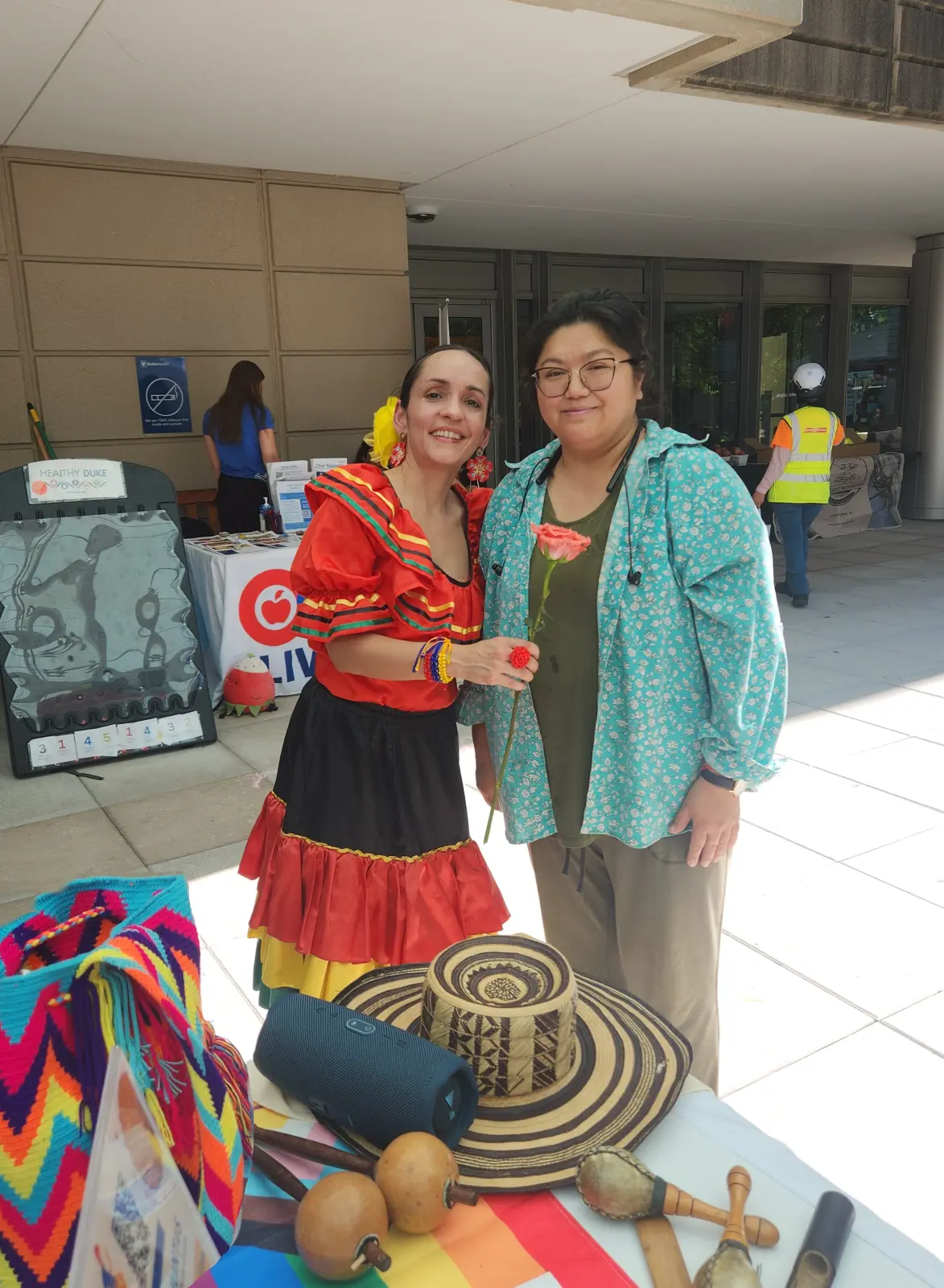 Angela Duran in traditional Colombian dress with a guest at the Duke Farmers Market